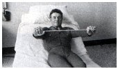 holding the exercise stretcher between hands over chest