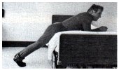 leaning on bed with 3 pound weight attached to one ankle